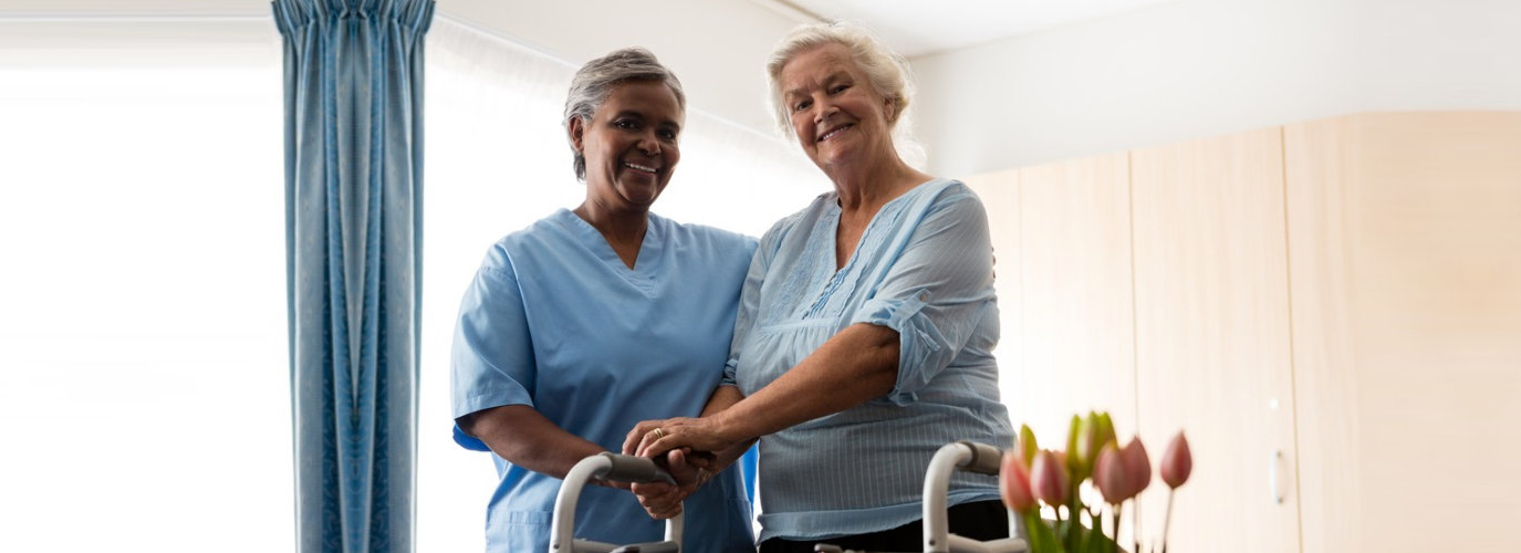 senior woman assisted by caregiver